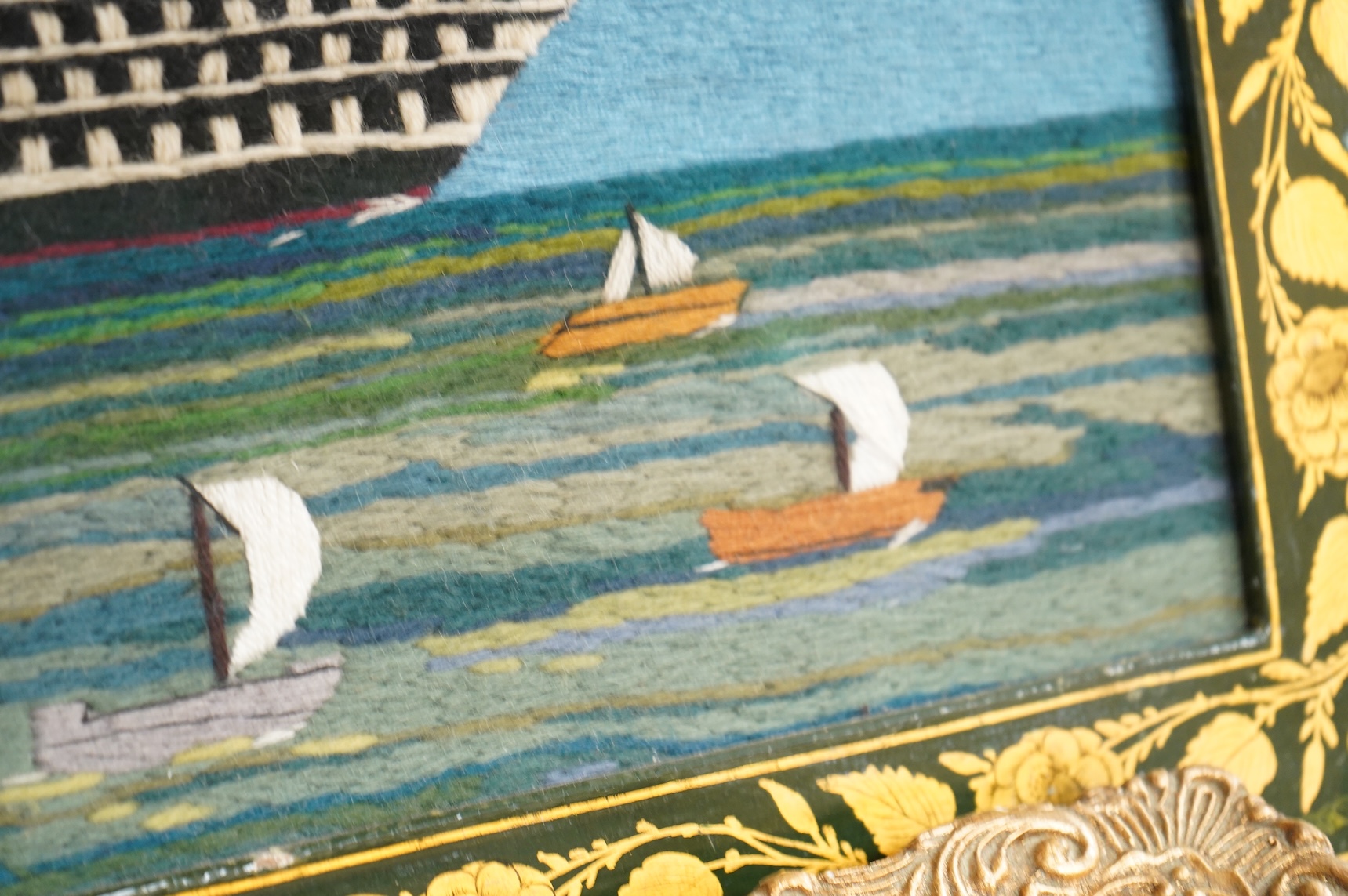 Two 20th century wool worked galleon embroideries and two similar yachting wool works, largest in decorative frame 36cm x 29cm